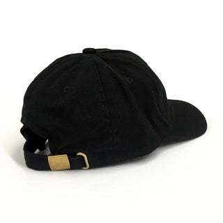 Black Dad Brand Girl Dad Hat shown from the side view, featuring a classic design and adjustable strap.