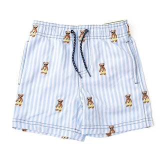 Boy wearing Shade Critters embroidered Teddy Icon swim trunks, colorful boys’ swimwear with teddy bear design, casual summer look.