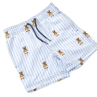 Boy wearing Shade Critters embroidered Teddy Icon swim trunks, colorful boys' swimwear with playful teddy bear design.
