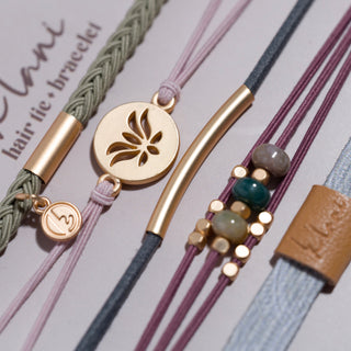 K'lani "Breathe" Lotus Flower Earthy Tones Hair Tie Bracelets
Collection of colorful bracelets with various designs on a light gray background