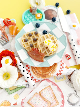 Earth Grown KidDough EGKD Sunny Side Diner KidDough Play Kit
Assorted pastries and waffles on a colorful tablecloth with decorative elements.