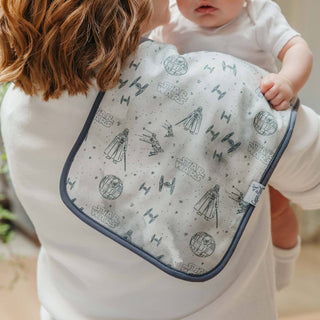 Copper Pearl Star Wars Tatooine™ Burp Cloth Set
Person holding a baby with a Star Wars-themed bib