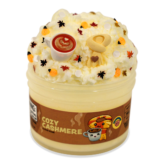 Peachybbies Cloud Slime - Cozy Cashmere
A novelty whipped cream-style product in a clear plastic tub with a brown label reading 'COZY CASHMERE.' The top is decorated to look like whipped cream, with small orange pumpkin accents, black and red leaf details, a small beige hat, and a white cup with red swirl.