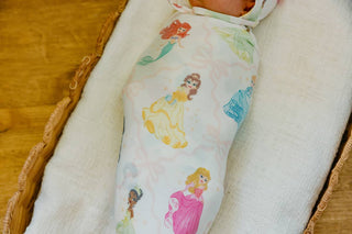 Copper Pearl Disney Princess Knit Swaddle Blanket
Baby swaddled in a blanket with princess designs on a wooden surface