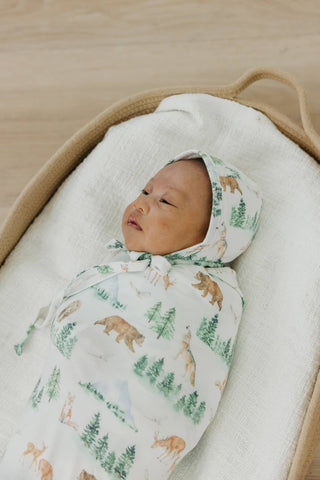 Copper Pearl Grayson Swaddle Blanket
Baby wrapped in a blanket with bear pattern in a crib