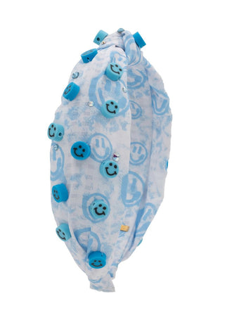 Bari Lynn Clay Smiley Jeweled Knot Headband - Blue
A light blue and white patterned headband decorated with blue smiley face charms and small rhinestones, shown against a plain white background.