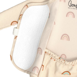Bonsie Footie - Little Wishes
Close-up of a baby outfit or diaper cover with a white textured insert pad attached along the side, featuring a soft rainbow print in muted pink, orange, and teal on a light beige background. The brand name Bowly is partially visible in script on the upper right.