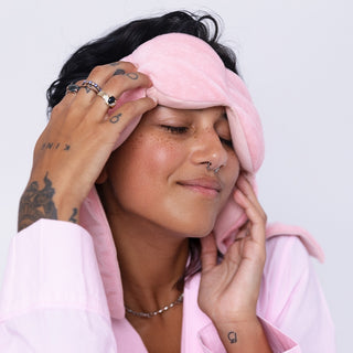 Noppod Weighted Sleep Eye Mask - Blush
Person wearing a pink sleep mask with a plain background