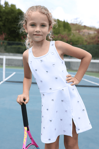 Lavender Lola & The Boys Heart Scuba Tennis Dress displayed on a hanger, showcasing its vibrant color and classic design.