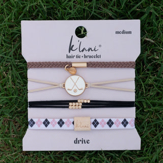 K'lani "Drive" Black & Cream Hair Tie Bracelets with Removable Ball Marker
K'lanii hair tie and bracelet set on a display card with grass background