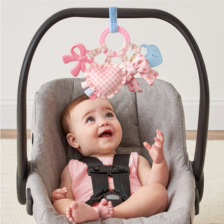 Itzy Ritzy Bow Bitzy Busy Ring™ activity toy with colorful rings and bow design for babies to explore and chew