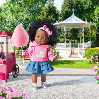 Corolle Maelys 14" Doll
Doll in a pink hoodie and blue skirt holding pink cotton candy in a park setting with a gazebo.