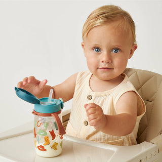 Itzy Ritzy Itzy Sips™ Straw Cup - Giddy Up
Baby in a high chair holding a colorful sippy cup with a white background