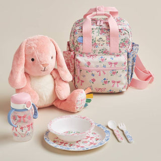 Itzy Ritzy Itzy Bistro™ Dining Set - Ribbons & Roses
Floral-patterned backpack with plush bunny, sippy cup, bowl, plate, and cutlery on a beige background