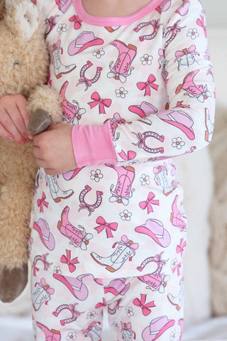 Caden Lane Rodeo Dreams Pink two-piece pajama set for kids, featuring pink fabric with a playful rodeo theme and comfortable fit.
