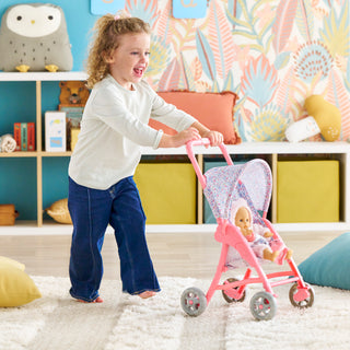 Corolle Floral Baby Doll Stroller with Folding Canopy for 12" Doll
Child playing with a pink doll stroller in a colorful room