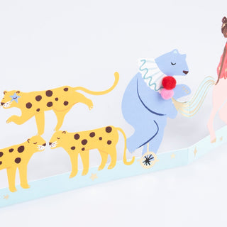 Meri Meri Circus Concertina Birthday Card
Illustration of a blue bear with pom-poms, yellow cheetahs, and a pink flamingo on a light blue background.