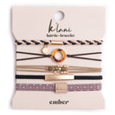 K'lani "Ember" with Tortoise Shell Ring Charm Hair Tie Bracelets
A set of thin elastic hair ties with gold-toned metal rings and patterned bands, displayed on a beige backing card. The card shows the brands 'kiki' and 'embar' in black text.