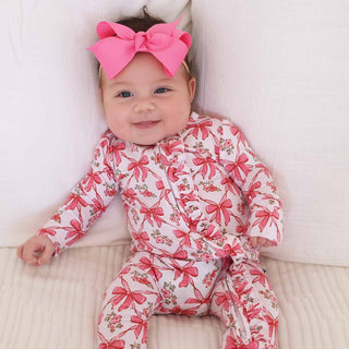 Caden Lane Bow Besties ruffle zipper footie for babies, featuring soft fabric, ruffle details, and a front zipper closure.