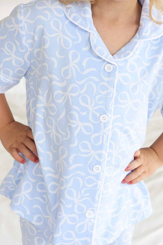Caden Lane girl's two-piece flare lounge pajama set in blue with bows, featuring a comfortable top and matching pants.