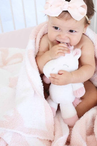 Light pink Caden Lane Cuddlelane Luxe blanket with bow details, soft and cozy for babies or children.