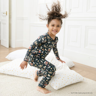 Magnetic Me Harry Potter First Year Modal L/S Pajama Set
Child wearing a patterned pajama set sitting on pillows in a room with white walls.