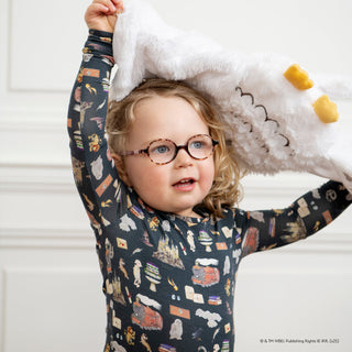 Magnetic Me Harry Potter First Year Modal L/S Pajama Set
Child wearing a patterned shirt with arms raised, sitting on a white surface.
