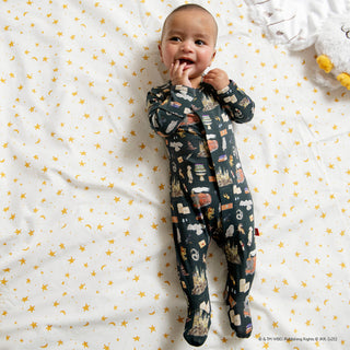 Magnetic Me Harry Potter First Year Footie
Baby wearing a patterned onesie on a white blanket with yellow star designs