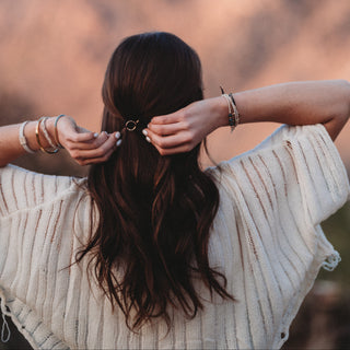 K'lani "Flirt" Polka Dot in Cream and Black Hair Tie Bracelets
Person with long hair standing in front of a mountainous landscape