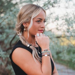 K'lani "Flourish" Natural Butterfly Hair Tie Bracelets
Woman with styled hair and jewelry outdoors