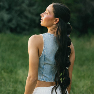 K'lani "Flourish" Natural Butterfly Hair Tie Bracelets
Woman with long braided hair standing in a grassy field