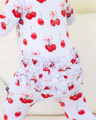 Lev Baby Ruffled Zippered Footie in Alice pattern, soft fabric, with ruffled details and front zipper for easy dressing.