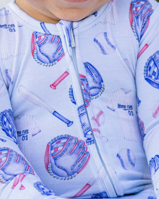 Lev Baby Zippered Footie - Home Run
Close-up of a baby wearing a onesie with baseball-themed print