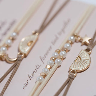 K'lani "Forever Friends" Neutral Sun Friendship Hair Tie Bracelets
Decorative hair sticks with pearls and gold accents on a pink background