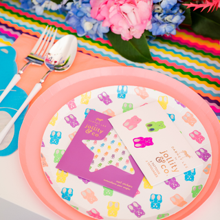 Jollity & Co Gummy Bears Nail Stickers
Colorful table setting with pink plates, colorful napkins, and a floral arrangement.