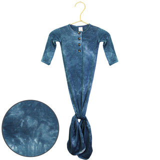 Lou Lou and Company Knotted Gown - Heath
Blue tie-dye baby onesie on a hanger with a close-up of the fabric texture.