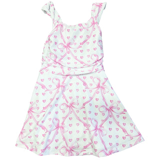 White dress with pink bow and heart details by Flowers By Zoe, featuring a charming poly dress design.
