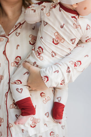 In My Jammers Bear-y Merry Zipper Romper
Person wearing pajamas with a child in matching pajamas on a light gray background