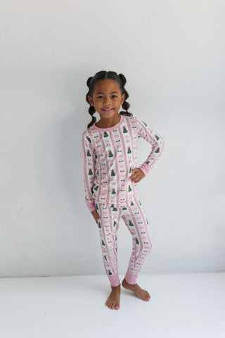 In My Jammers Pinkmas Two Piece Set 
Child wearing pink pajamas with a pattern on a white background
