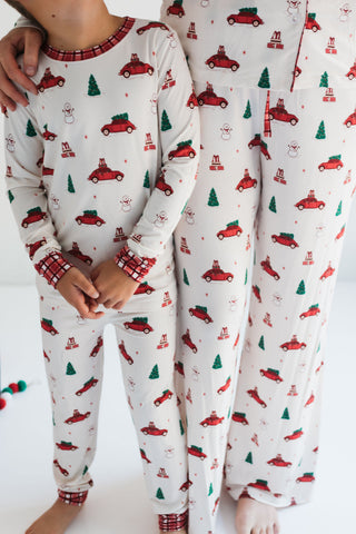 In My Jammers Red Holly Jolly Cruisers Two Piece Set
Children's pajamas with Christmas car and tree pattern on a white background
