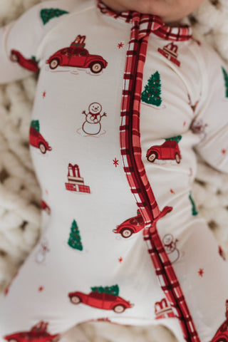 In My Jammers Red Holly Jolly Cruisers Zipper Romper
Baby outfit with Christmas-themed print and plaid trim