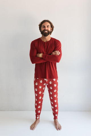 In My Jammers Santa Men's Jogger
Man wearing red pajama set with white paw prints on a plain background