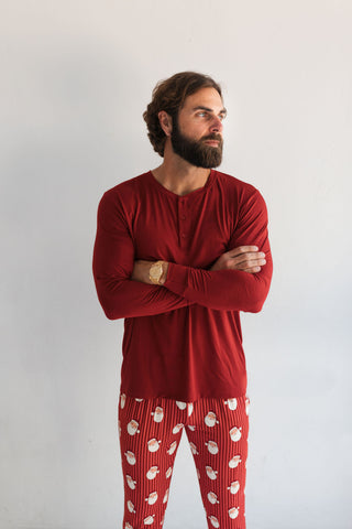 In My Jammers Solid Red Santa Men's Top
Man wearing red pajama top and patterned pants against a white background