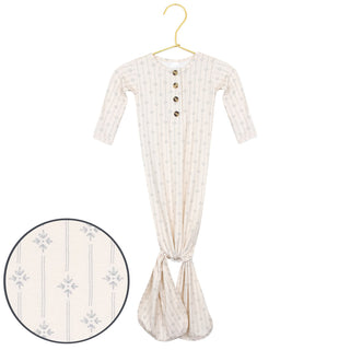 Lou Lou and Company Knotted Gown - Kit
Baby gown with long sleeves and buttons on a hanger, with a close-up of the fabric texture.