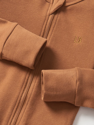 Little Bipsy 2-Way Zip Romper - Chestnut
Brown jacket with rolled-up sleeves and a visible brand logo on a neutral background