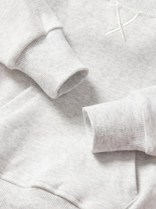 Little Bipsy Pocket Pullover - Light Heather Grey
Close-up of a gray sweater with a brand logo on a light gray background