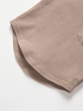 Little Bipsy Waffle Top - Mushroom
Close-up of a brown polo shirt with a brand logo on a white background