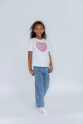 Lola and The Boys Crystal Stars Jeans Child wearing a white t-shirt with a red heart design and blue jeans on a light gray background
