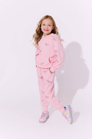Lola and The Boys Pretty in Crystal Bows Set Young girl wearing a pink outfit with bow patterns on a white background
