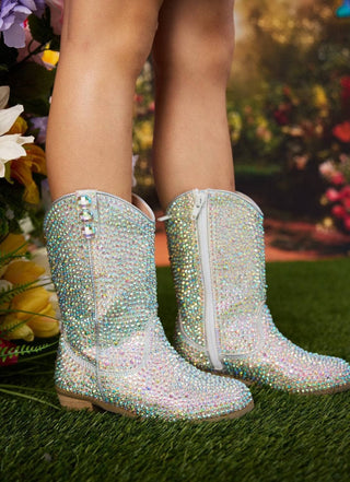 Lola and The Boys Silver Crystal Cowgirl Boots
Sparkly silver cowboy boots on a grassy background with flowers.
